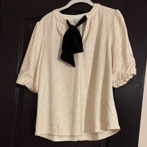 White blouse featuring black bow